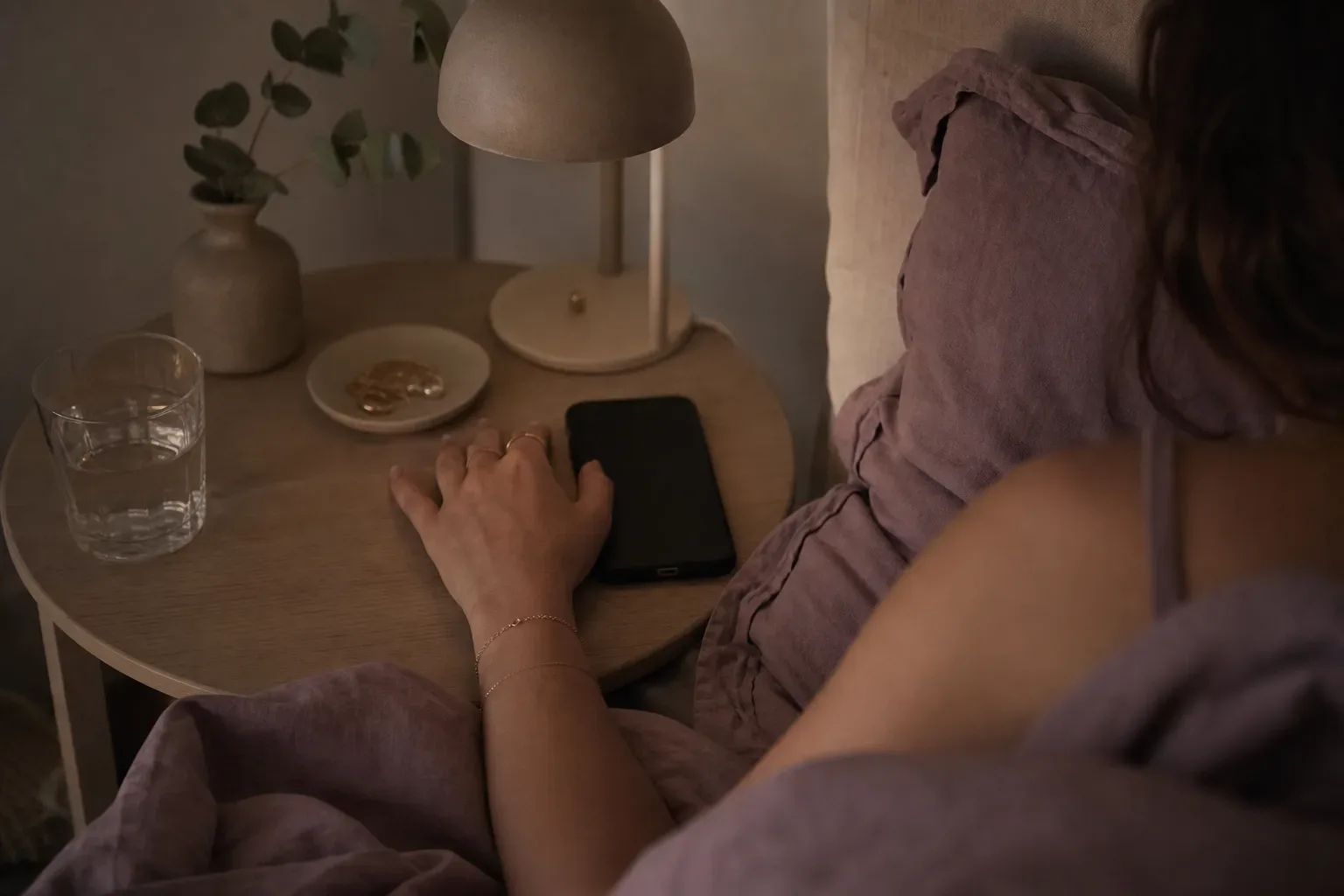 Person listening quietly in bed before sleep