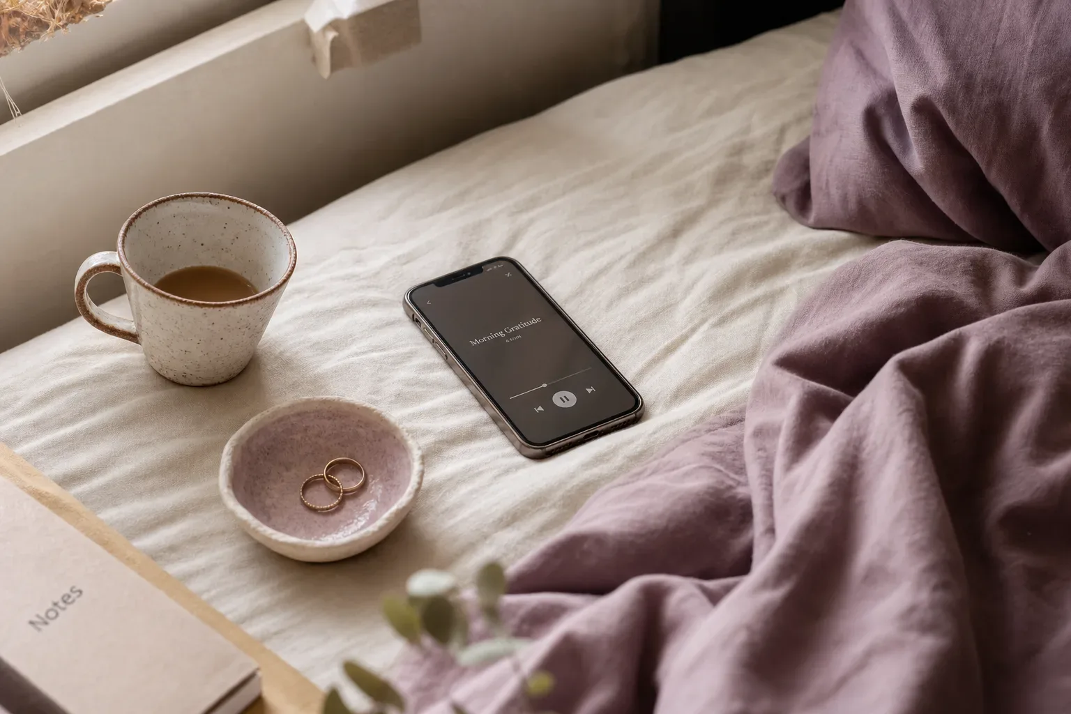 Quiet phone beside tea and a small ceramic bowl