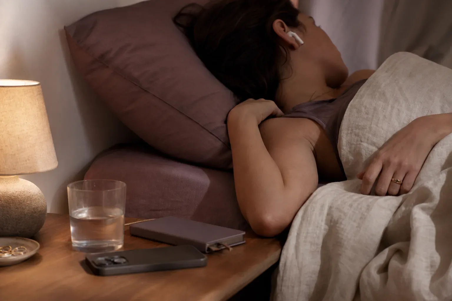 Woman listening quietly in bed before sleep